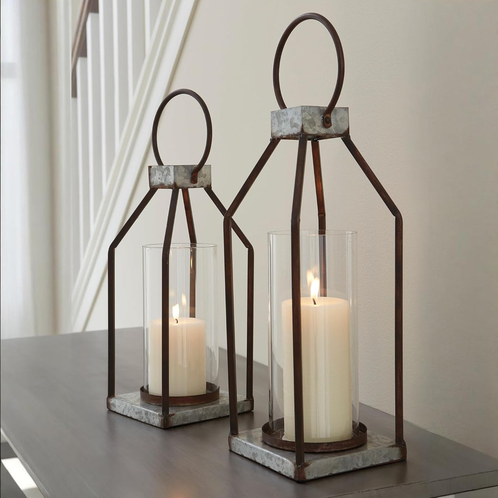 Signature Design by Ashley Diedrick Rustic Lantern, Set of 2, Indoor/Outdoor, Galvanized Metal, Antiqued Finish, Glass Shade, Holds 3 in. Pillar Candles (Not Included), 19" &17", Gray and Black